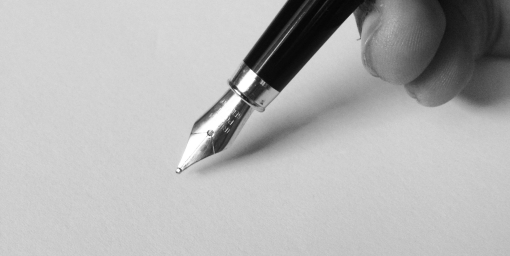 photo of hand holding a pen 