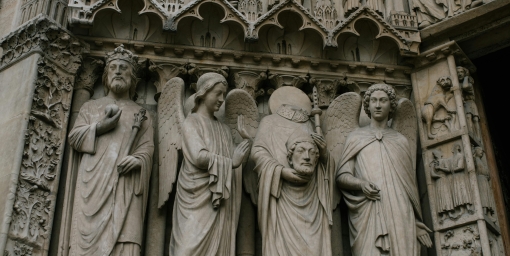 Medieval figures of saints on the stone entrance to the Church in Paris, author:  Julia Volk