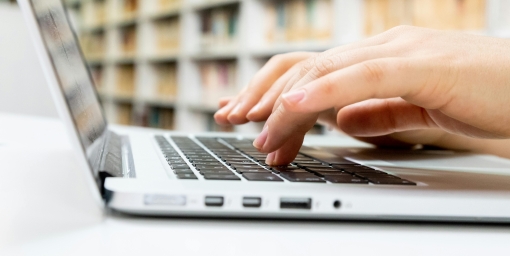 Photo of hands on a laptop keyboard, author: Donatello Trisolino