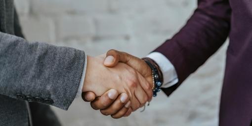 Handshake of two people in jackets